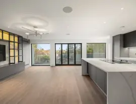 A state-of-the-art new building in a quiet cul-de-sac with spacious side living areas, outstanding design quality and