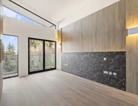 A state-of-the-art new building in a quiet cul-de-sac with spacious side living areas, outstanding design quality and