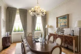 A lavish townhouse with a white stucco facade in Belgravia.