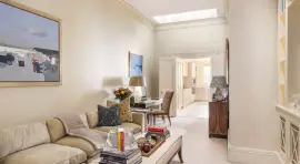 A lavish townhouse with a white stucco facade in Belgravia.